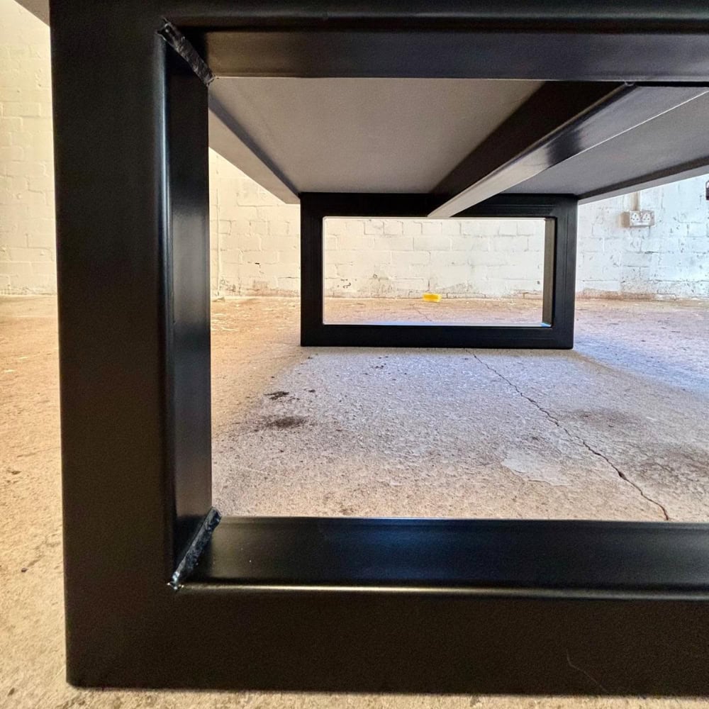 Close Up Of Black Square Metal Legs On Coffee Table